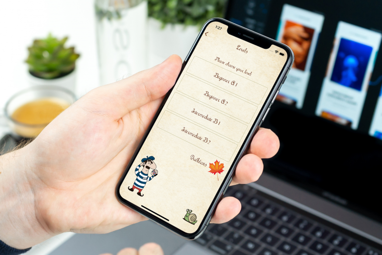 Free-Man-Holding-iPhone-X-Mockup-PSD
